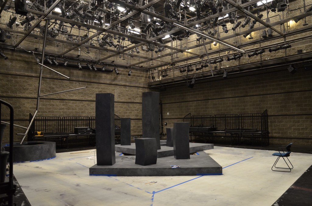 Set on the Black Box, consisting of four tall black pillars of different sizes