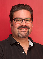 Gregg Schraven, a white man with short, dark hair, a dark beard and mustache, and rectangular black glasses