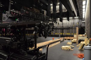 Proscenium Theatre stage, covered in plywood and carts of lights