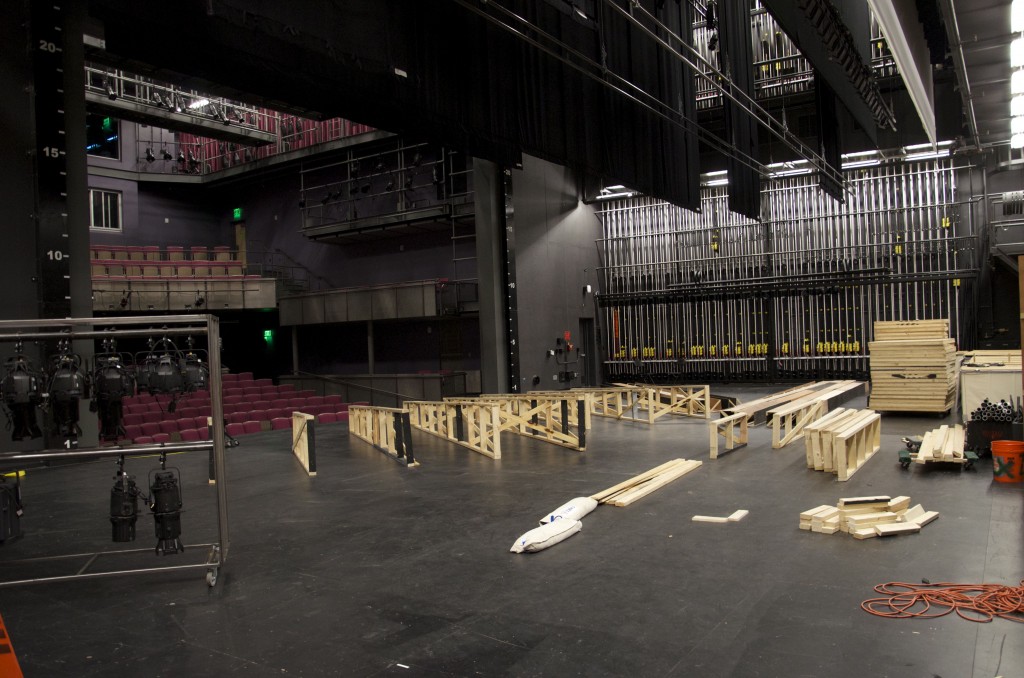 Proscenium Theatre stage, covered in work in progress set pieces