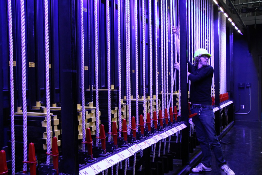 Student flies in a baton on the Proscenium Theatre's fly rail.