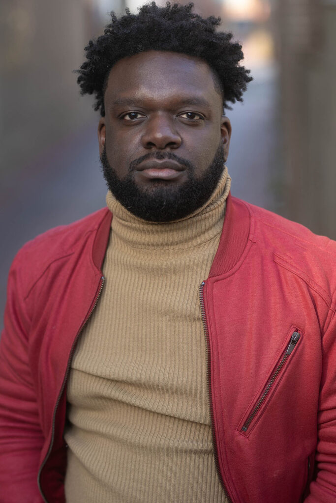 Headshot of Professor Gerrad Alex Taylor. He is Black, with a beard and short, dark hair.