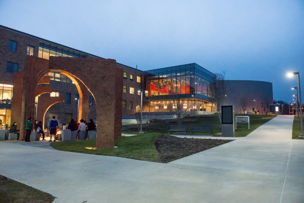 Exterior of the P-A-H-B at U-M-B-C. Featuring the arch installation outside of the entrance, and the Dance Cube.