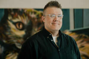 Headshot of Professor Eric Abele. He is white, with glasses and short hair.